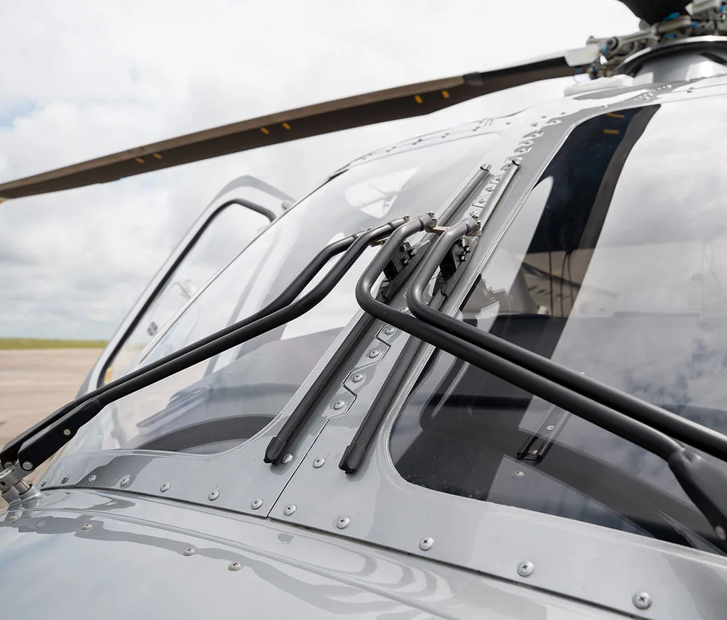 Close-up view of the AgustaWestland AW169 helicopter's windshield with wipers and rivets visible.