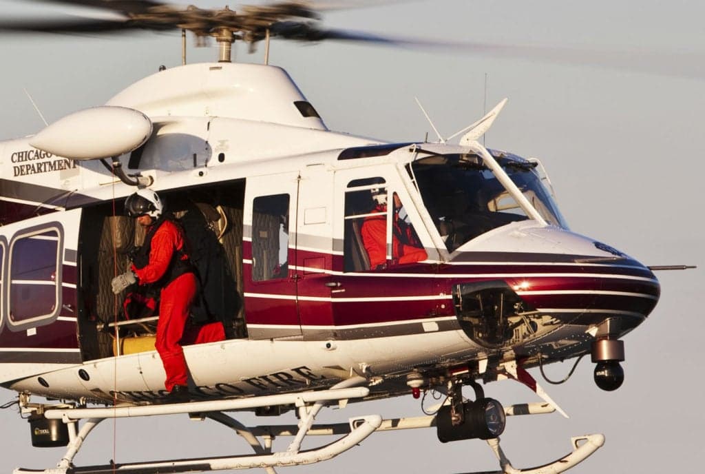 Chicago Fire Department Bell 412 helicopter with a firefighter entering.