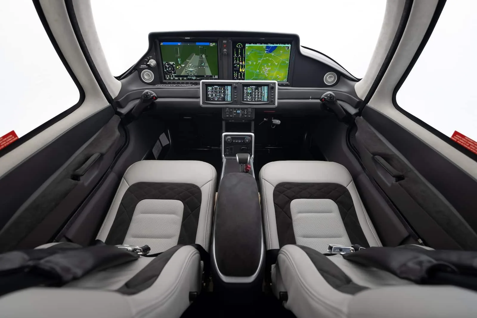 The cockpit of a Cirrus aircraft features modern avionics and comfortable seating.