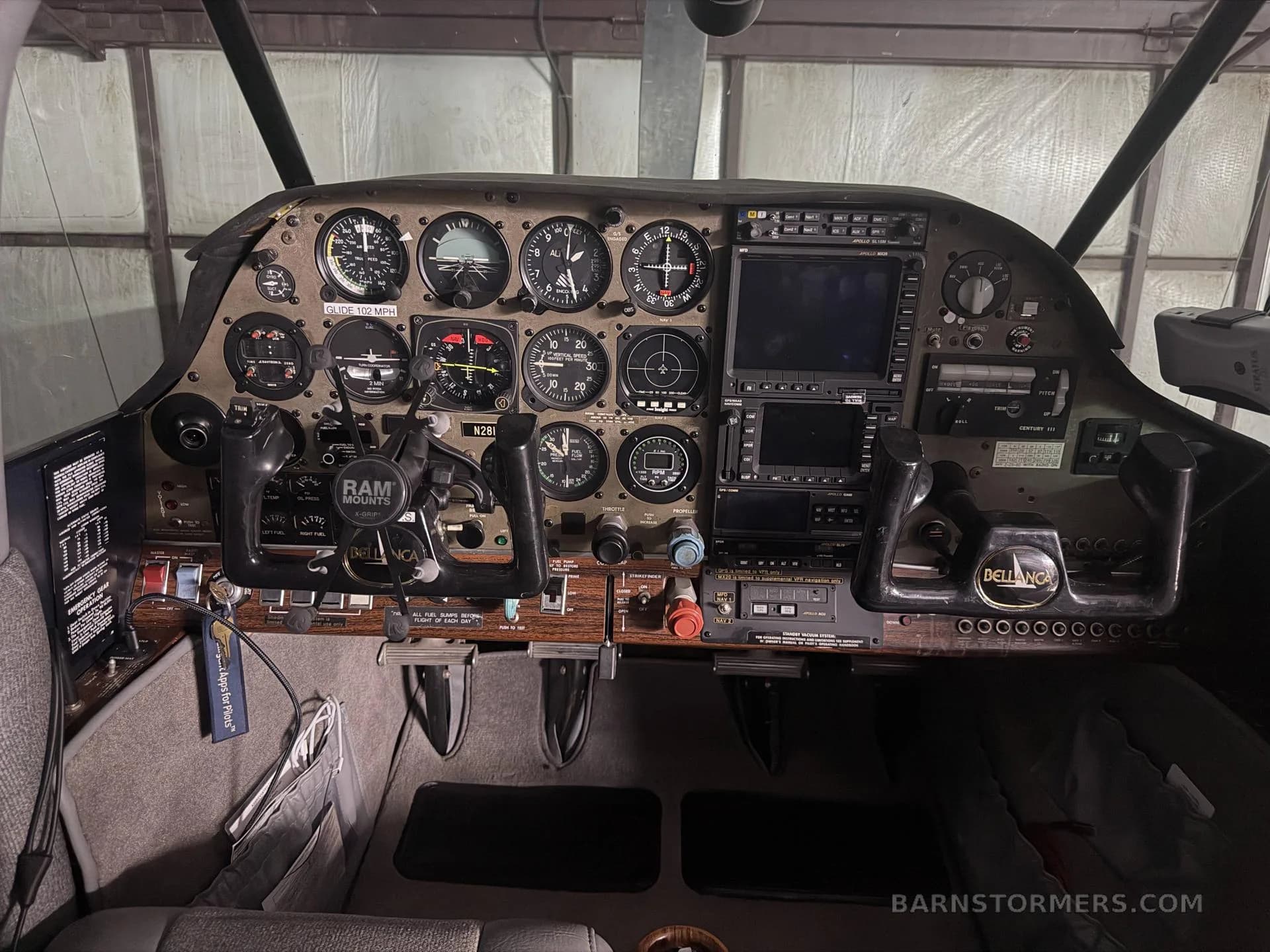 The cockpit instrument panel of a Bellanca aircraft, featuring analog gauges and modern digital displays.