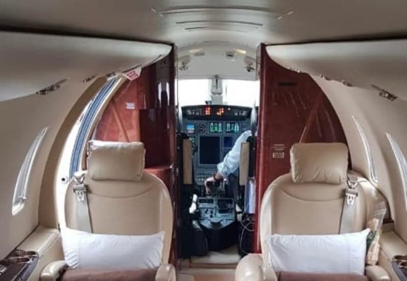 A view of the cockpit from the cabin of the aircraft.