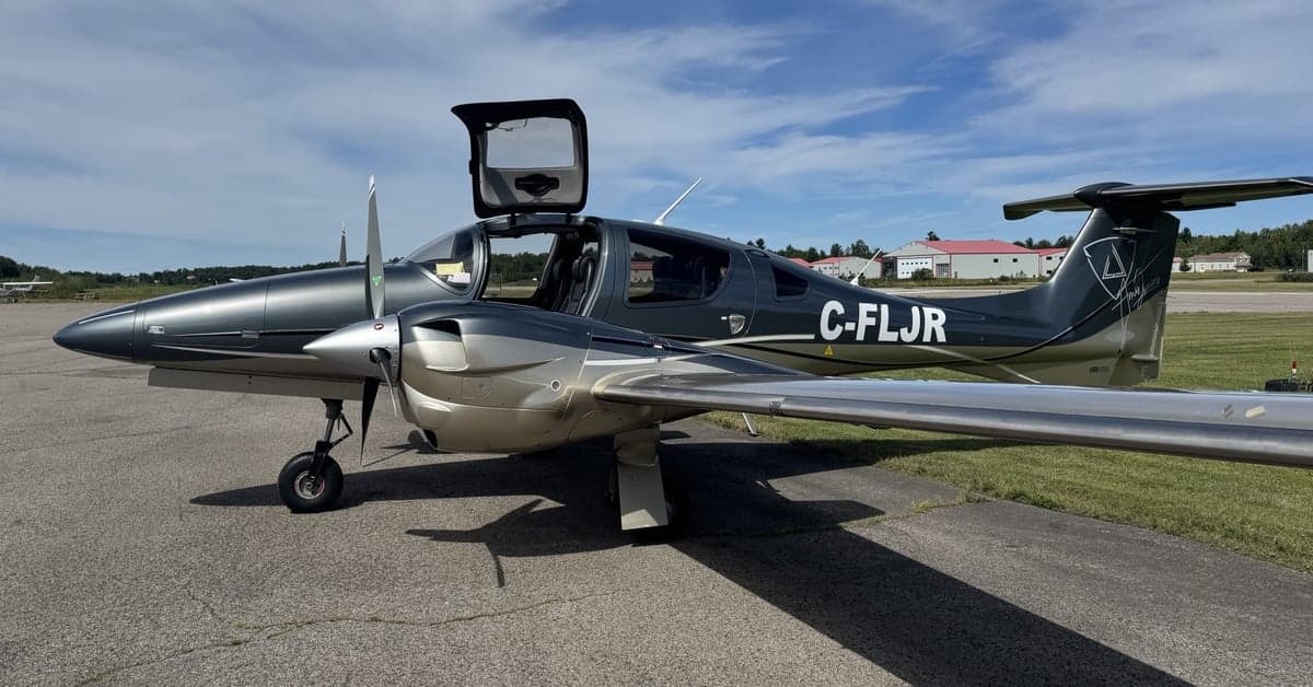 Diamond DA62 aircraft with open gull wing door on the tarmac.