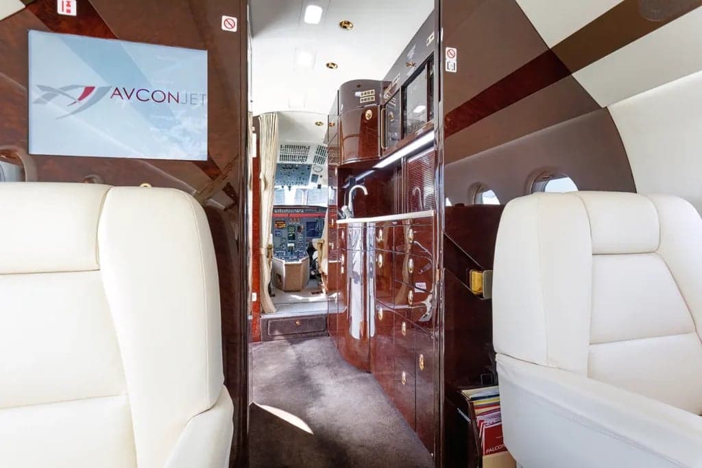 A view of the aircraft interior showing the cabin, lavatory, and cockpit.