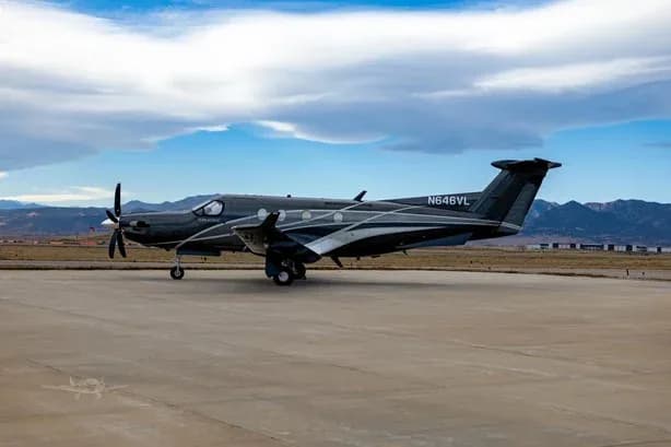 Pilatus PC-12 aircraft N646VL is parked on the tarmac with a cloudy sky overhead.