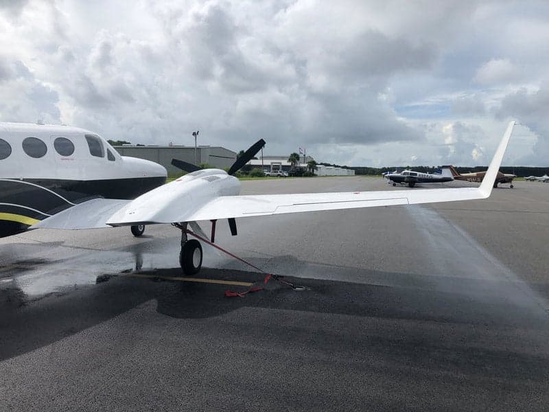 The N513JN aircraft is parked on the tarmac next to another aircraft.