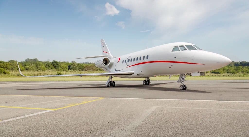 A Falcon aircraft is parked on the tarmac.