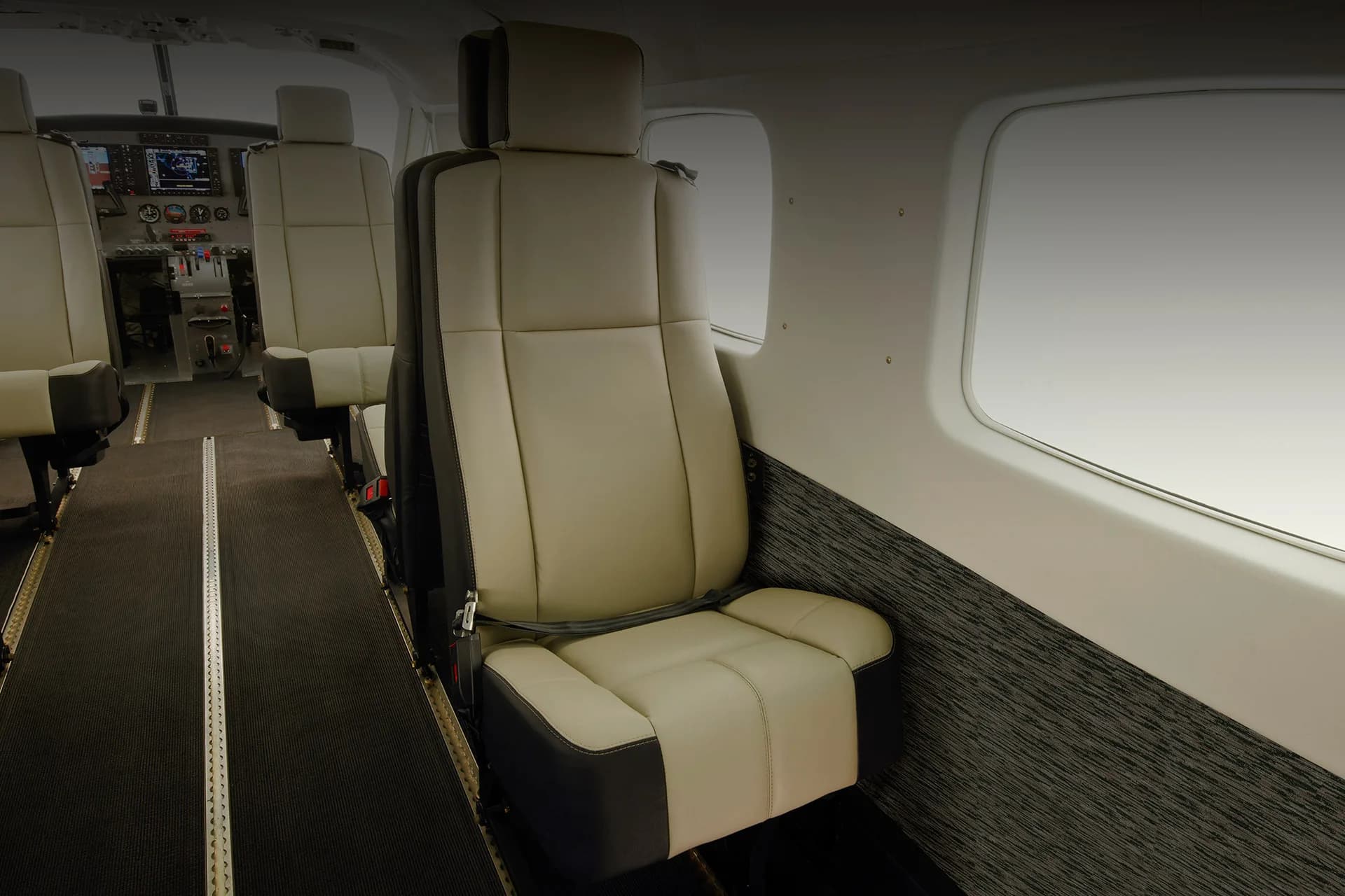 Cabin interior of a Cessna Grand Caravan with a single seat and window.