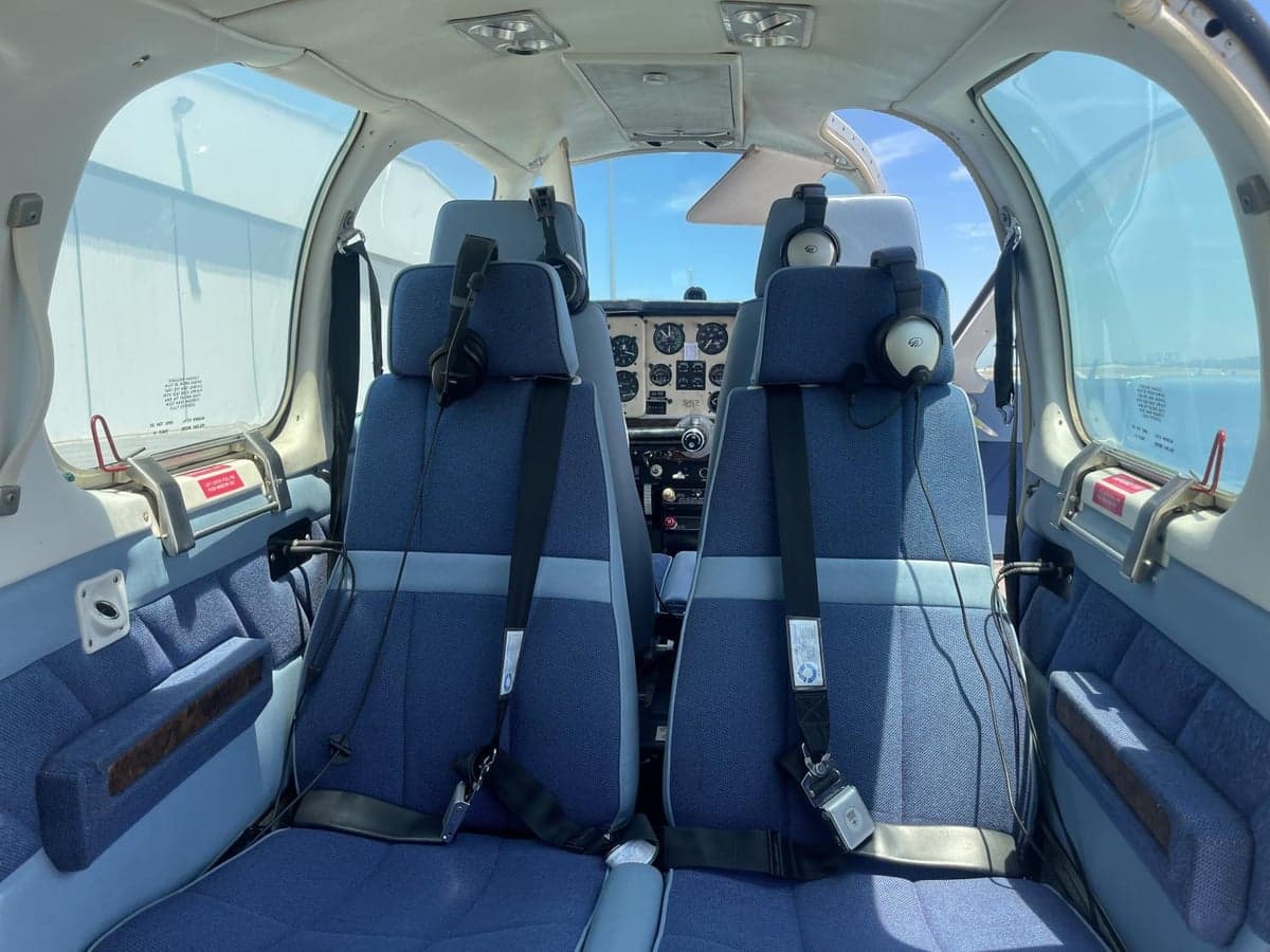View of the aircraft's blue cloth seats and cockpit.