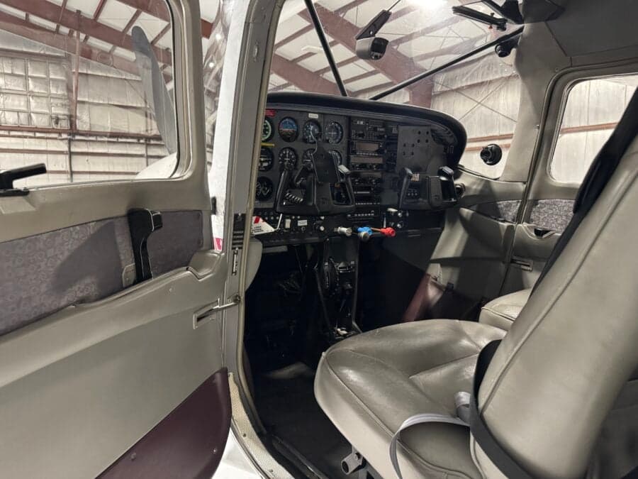 View of the Cessna 206 cockpit from the open door.