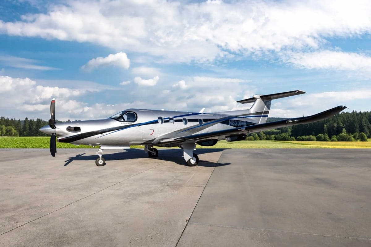 Pilatus PC-12NG on the tarmac with a silver and black paint scheme.