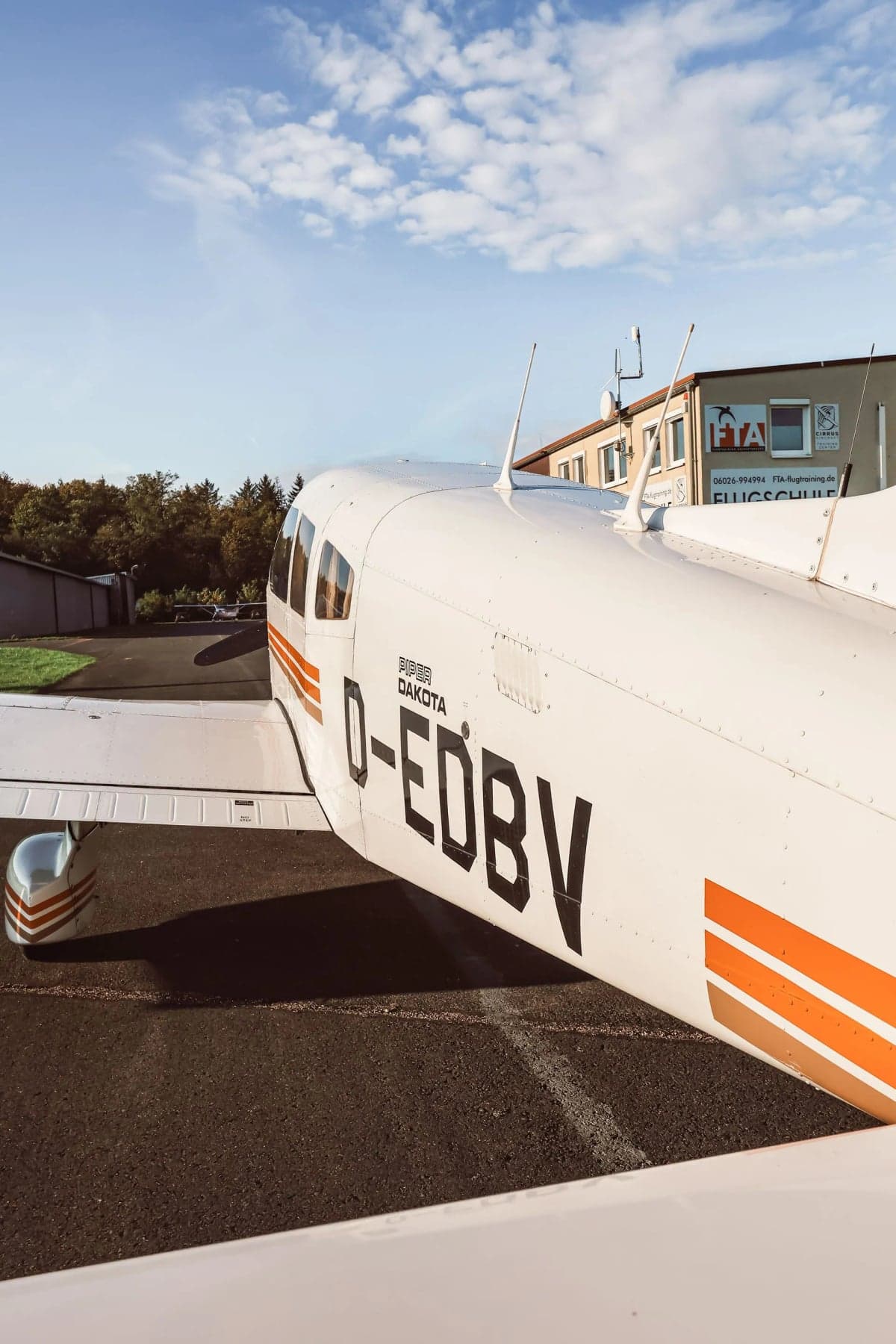 Piper Dakota D-EDBV with orange stripes on the fuselage.