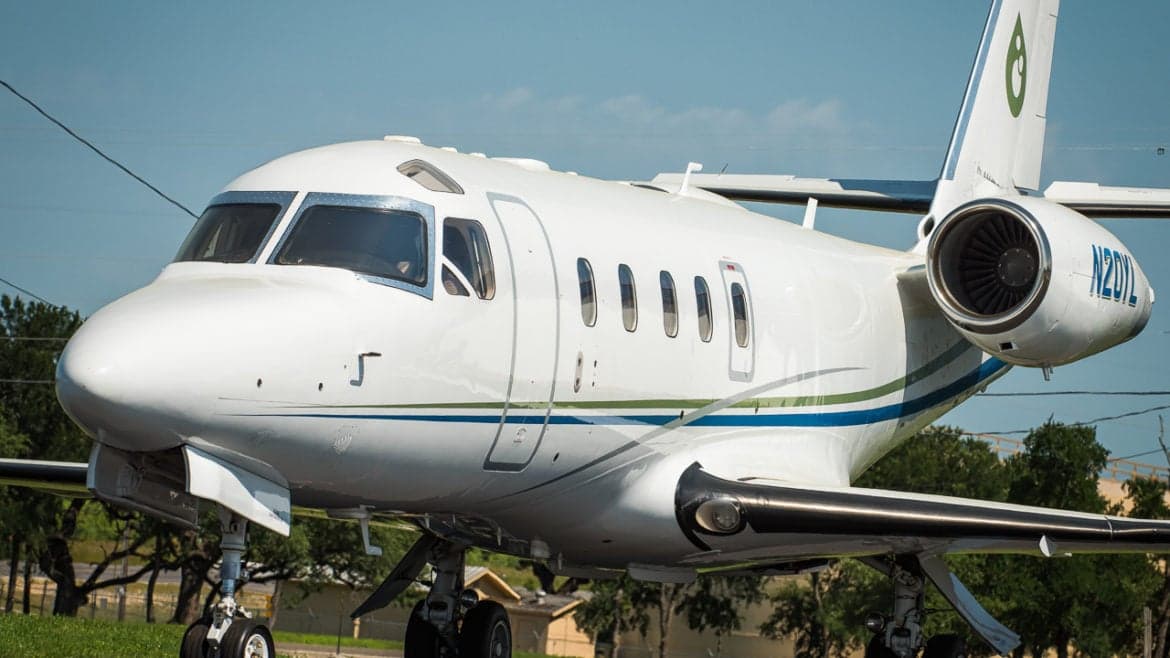 Close-up of the Astra SPX aircraft N20YL showing the cockpit windows and engine.