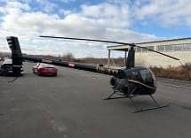 Robinson R44 helicopter OE-XYY parked on the tarmac.