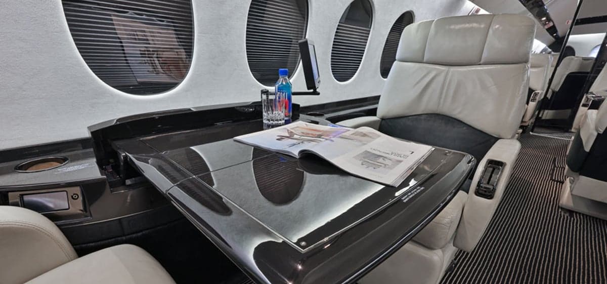 Close-up of a seat and table in the aircraft interior.