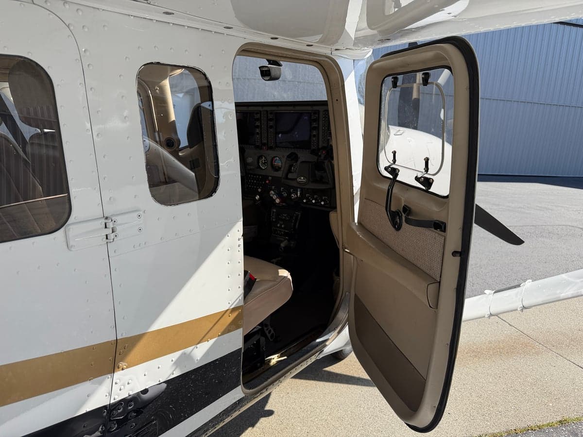 View of the cockpit and instrument panel from the open cabin door.