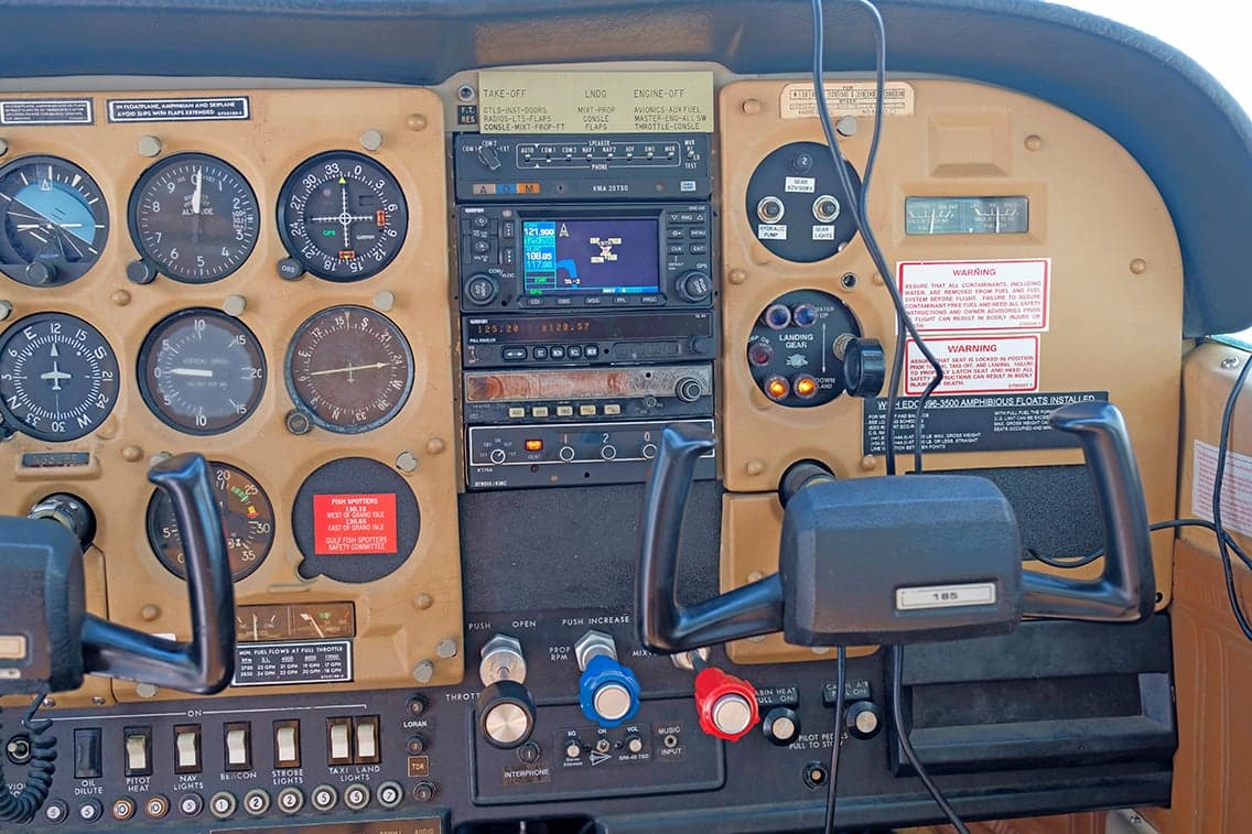 Close-up of the Cessna 206 instrument panel with various gauges and controls.
