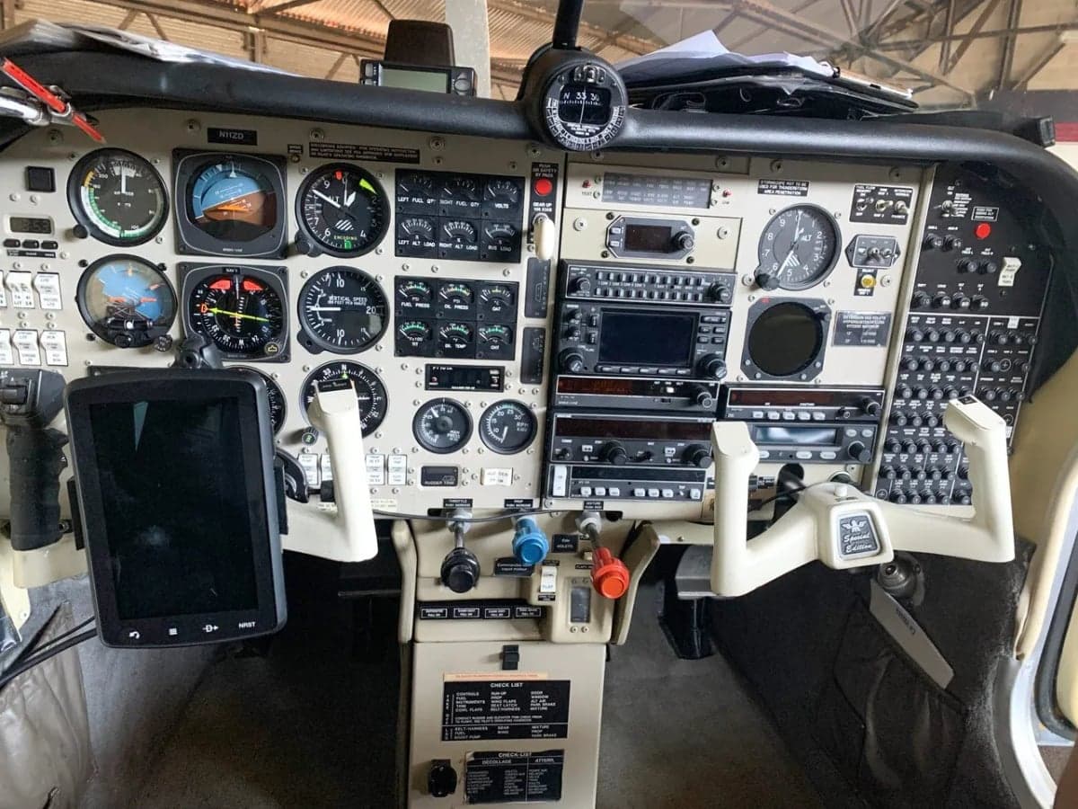 The cockpit of the Mooney M20C with instrument panel and yokes.