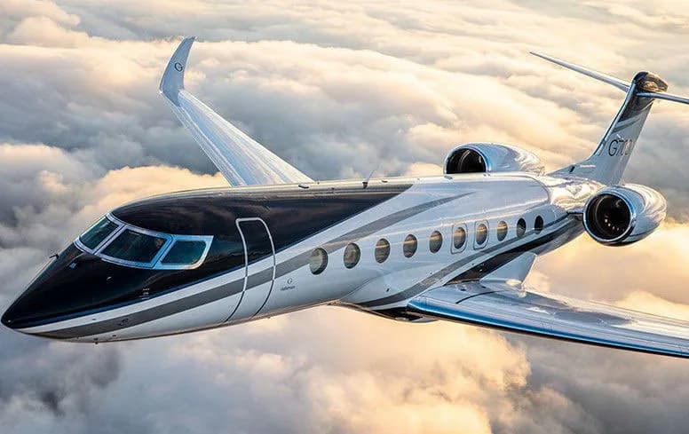 A Gulfstream G700 flying through the clouds.
