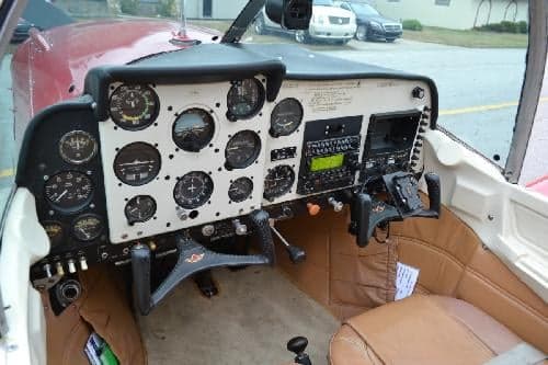 View of the aircraft cockpit showing the instrument panel and controls.