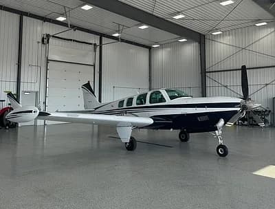 Beechcraft Bonanza in a hangar, side view.