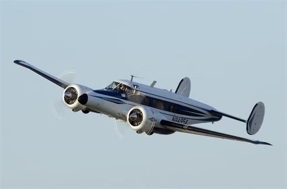 Beechcraft Model 18 with registration N8495A in flight.