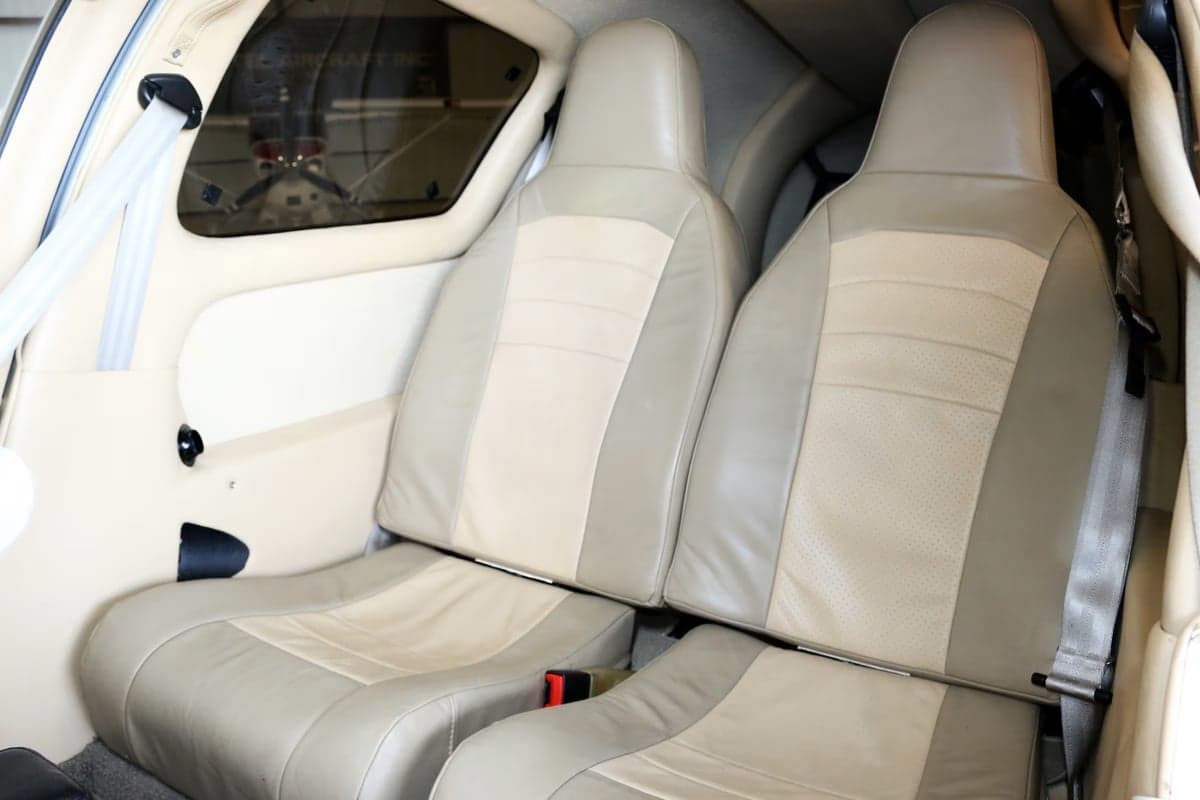 Beige leather seats in the cabin of a Columbia 350 aircraft.
