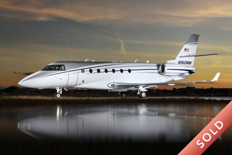 A Hawker 800XP business jet on the tarmac with a SOLD banner overlay.