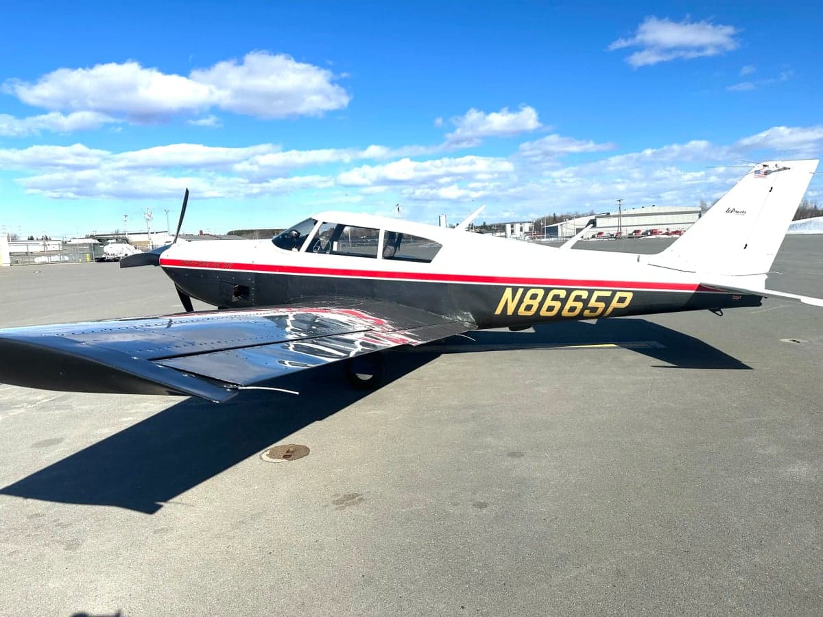 A Piper PA-28-181 Archer II aircraft with registration N8665P on the tarmac.
