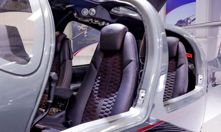 Diamond DA62 cabin seats with black leather and red stitching.