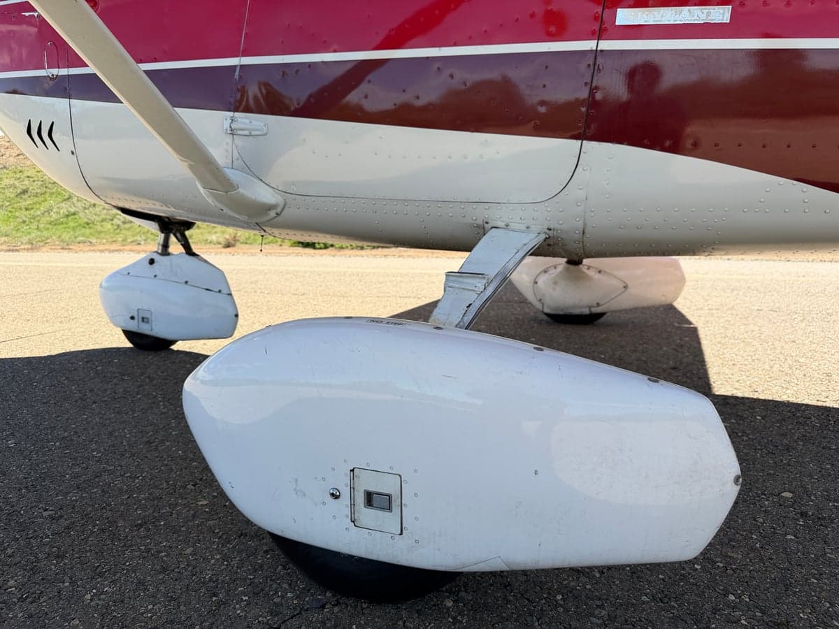 Interior view of the aircraft, showing the seats, door panel, and instrument panel.