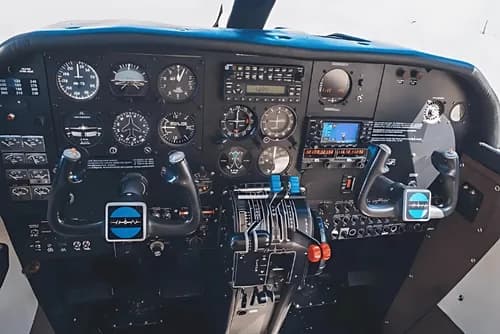 The cockpit of the aircraft shows the instrument panel and controls.