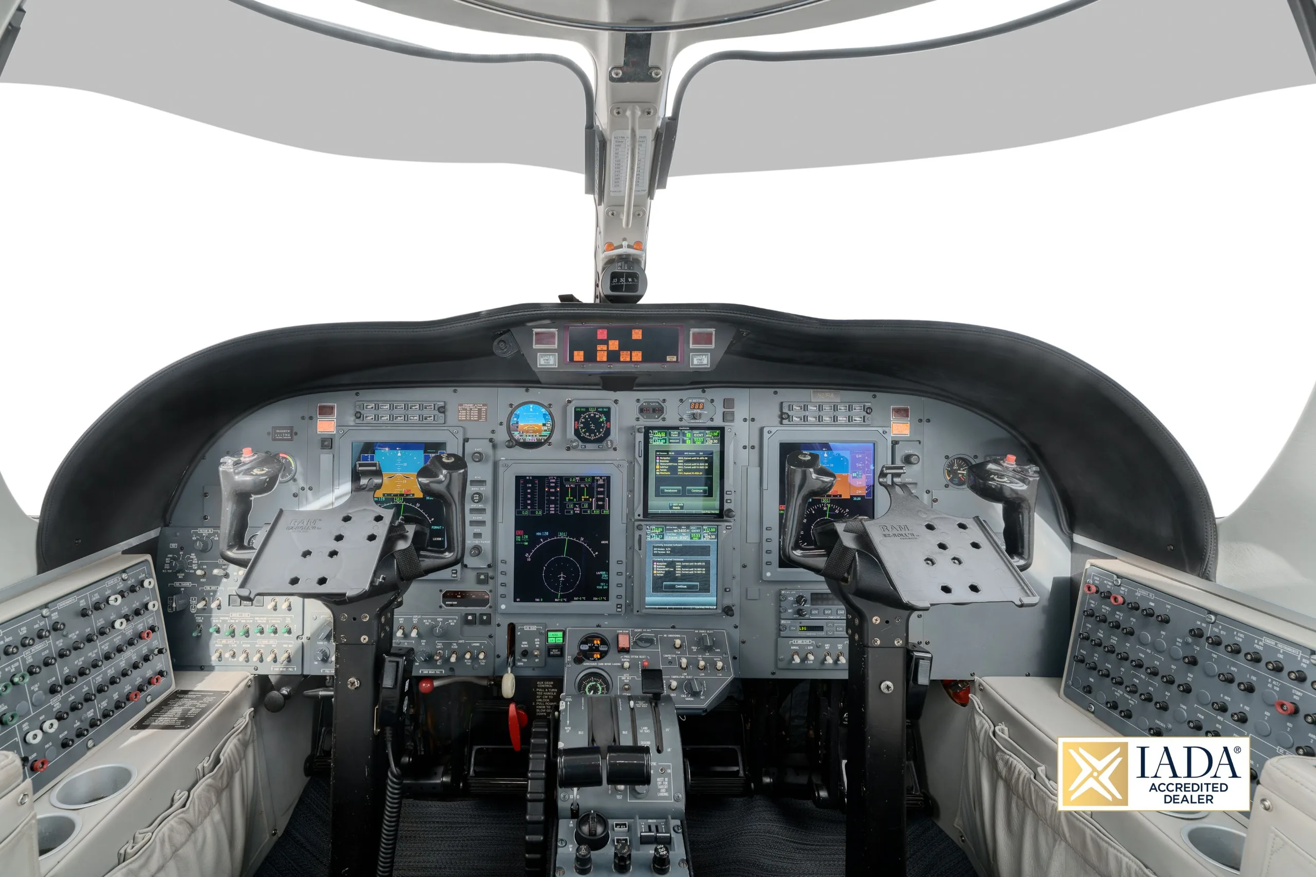 The cockpit of a Cessna Citation business jet, showing the instrument panel with multiple display screens.