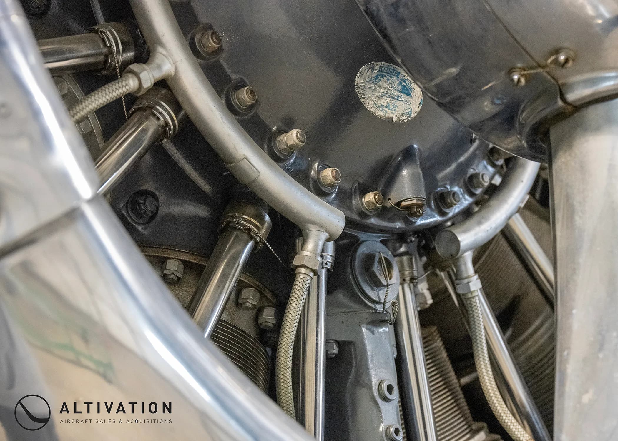 Close up of the engine of a silver aircraft.