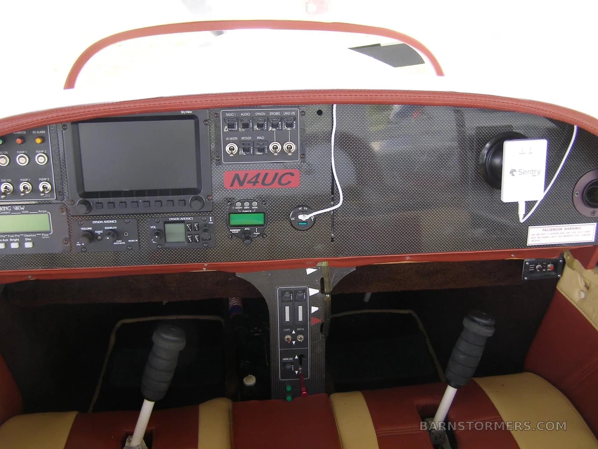 The cockpit instrument panel of an experimental aircraft, featuring a large display screen, various gauges, and controls.