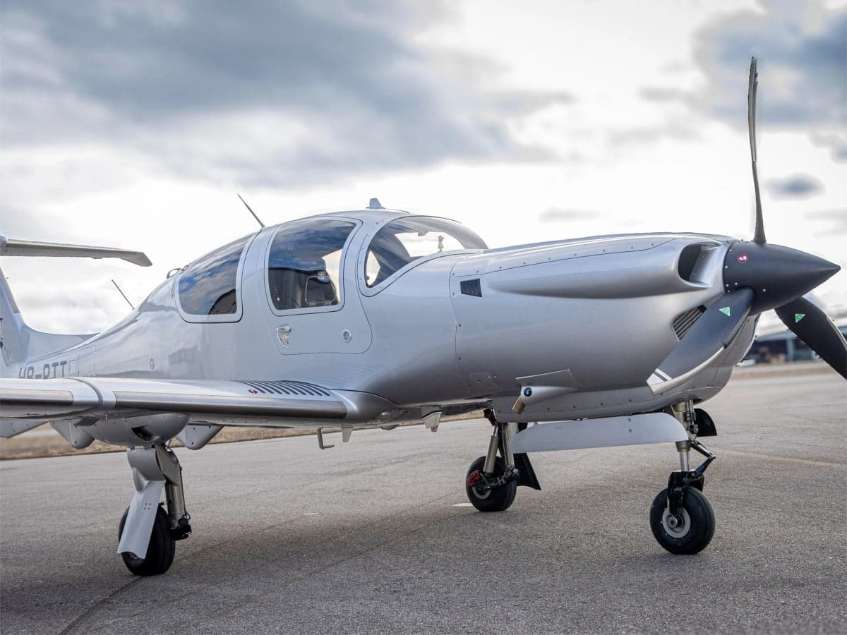 A silver Diamond DA40 aircraft on the tarmac.