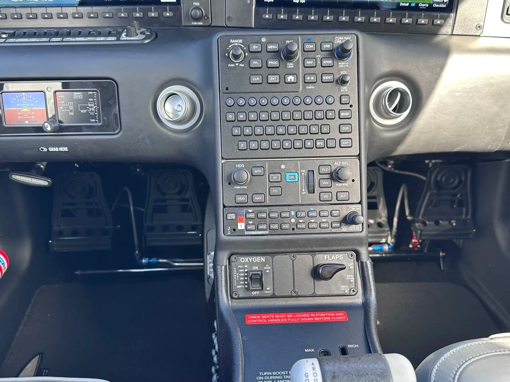 A close-up view of the central control panel and rudder pedals in the cockpit of the aircraft.