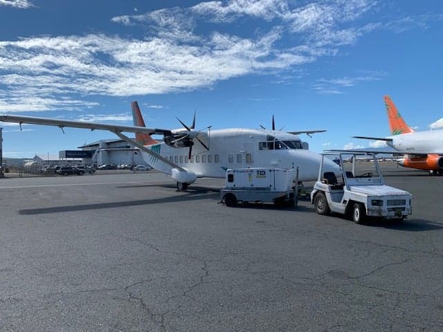 Front view of a white and orange Short 360 aircraft on the tarmac.