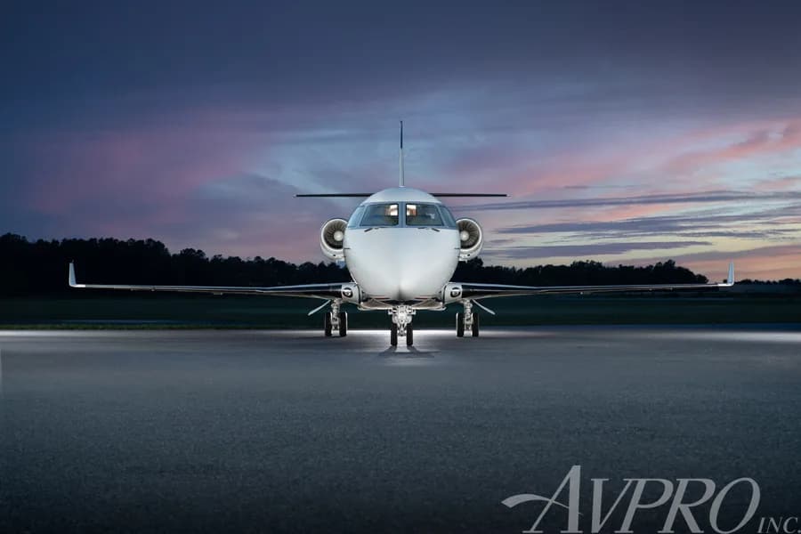 A head-on view of the Gulfstream G200 business jet, tail number N2G, on a tarmac at dusk.