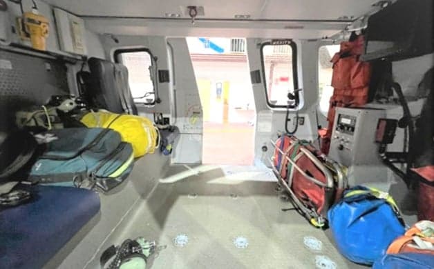 Cockpit view of a helicopter with multiple displays and controls.
