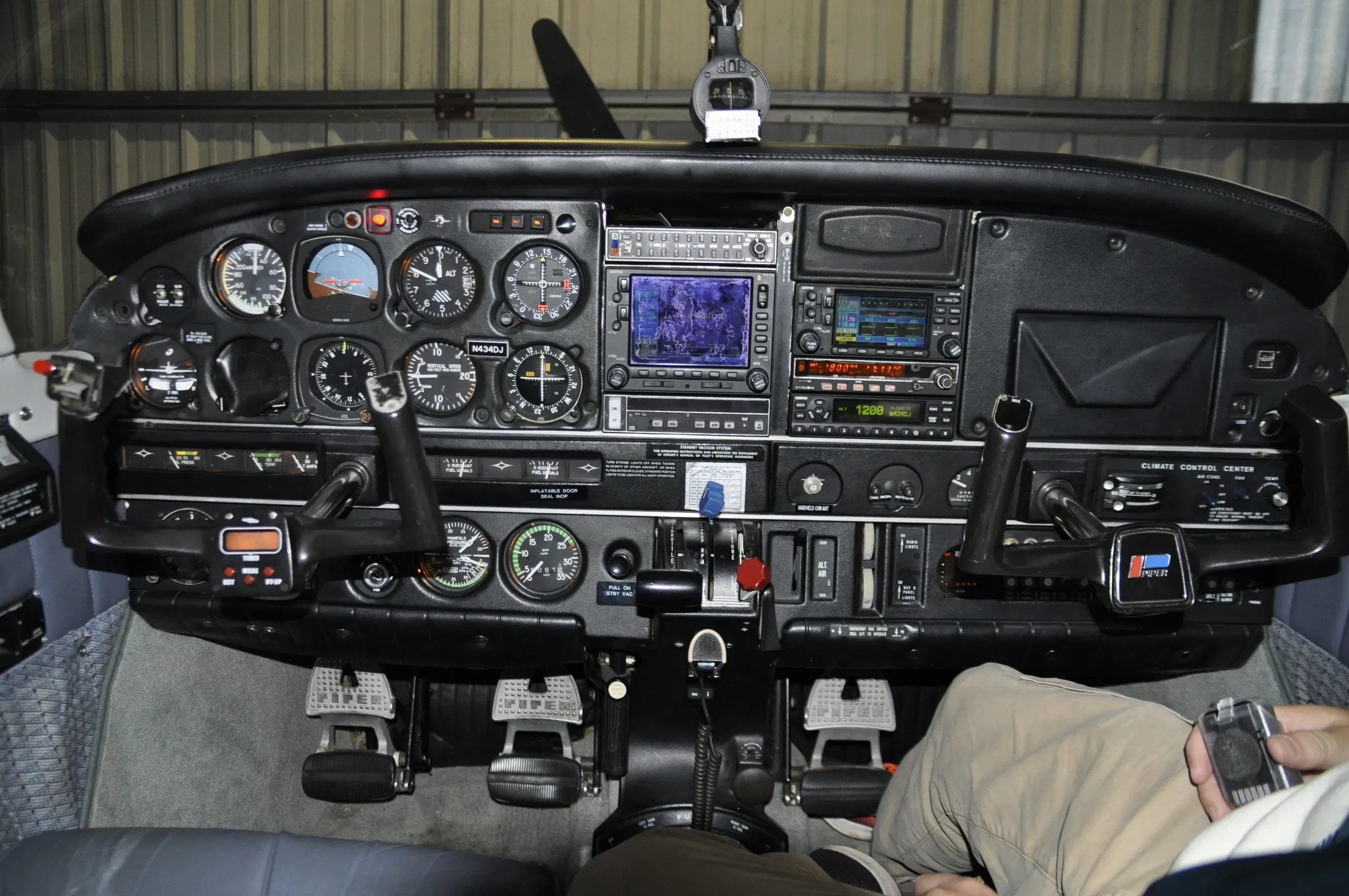 A detailed view of the aircraft's instrument panel, featuring dual yokes, multiple gauges, and modern avionics.