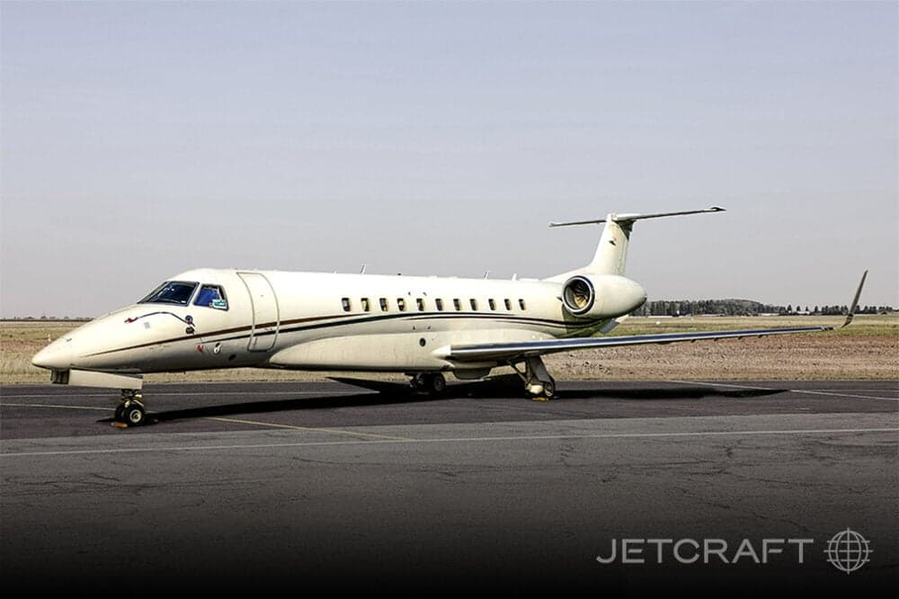 Side view of a white Embraer Legacy 650 on the tarmac.