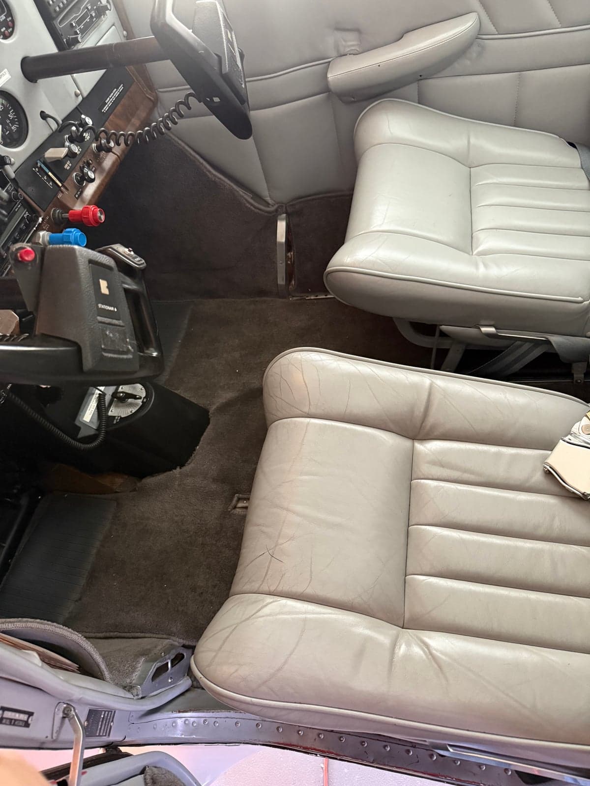 The interior of the aircraft showing the front seats and controls.
