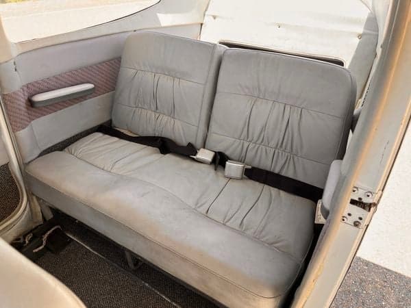 The rear seats of the aircraft N2680F, showing the seatbelts and upholstery.