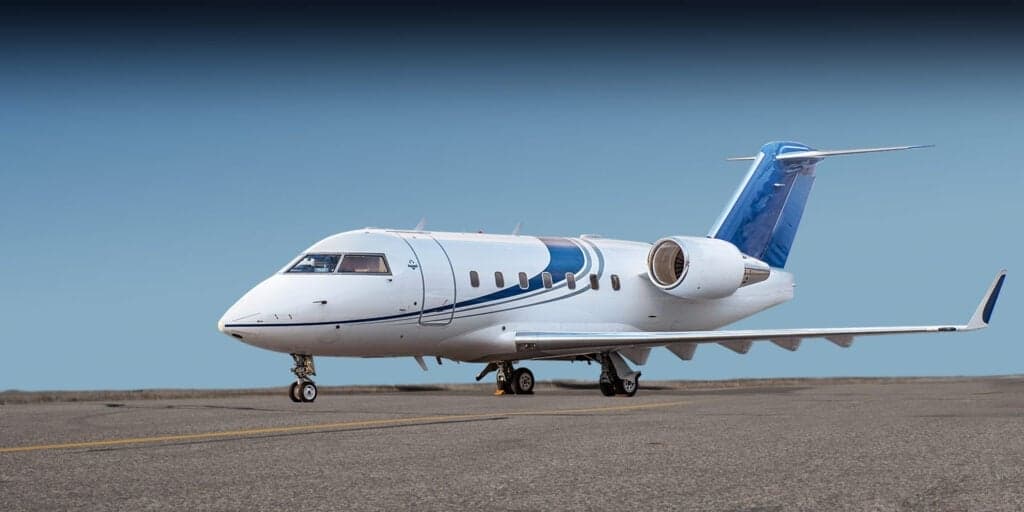 A Challenger aircraft parked on the tarmac with gold accents.