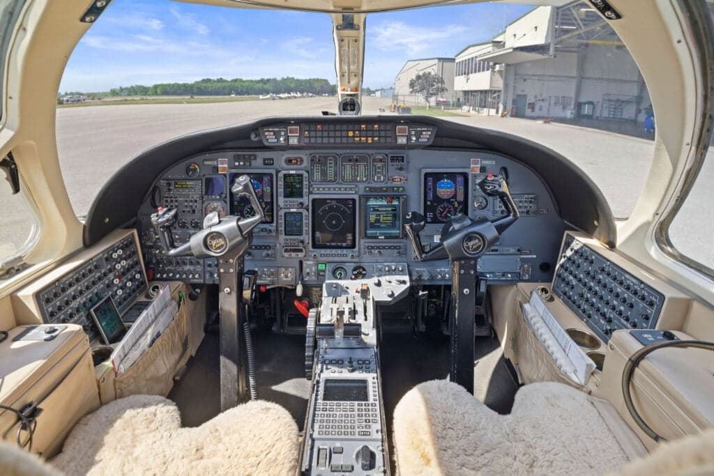 The cockpit of the aircraft features a full instrument panel and sheepskin seat covers.