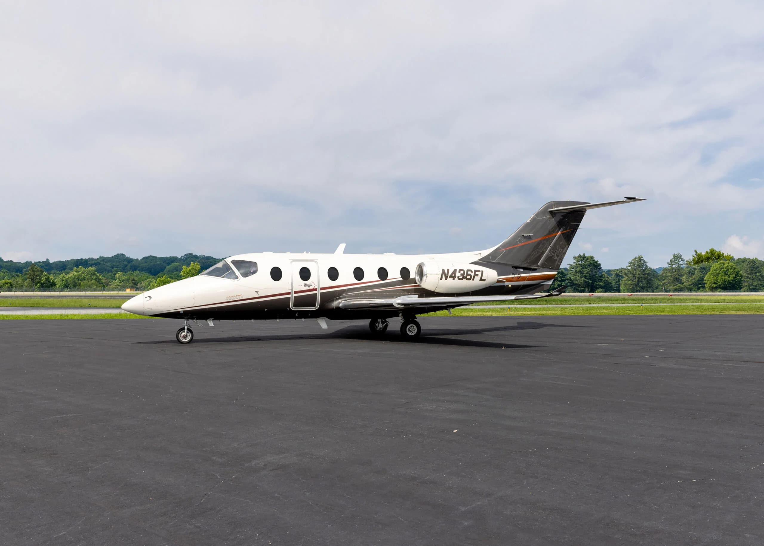 Side view of the N436FL jet on the tarmac.