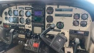 Aircraft cockpit with instrument panel and controls.