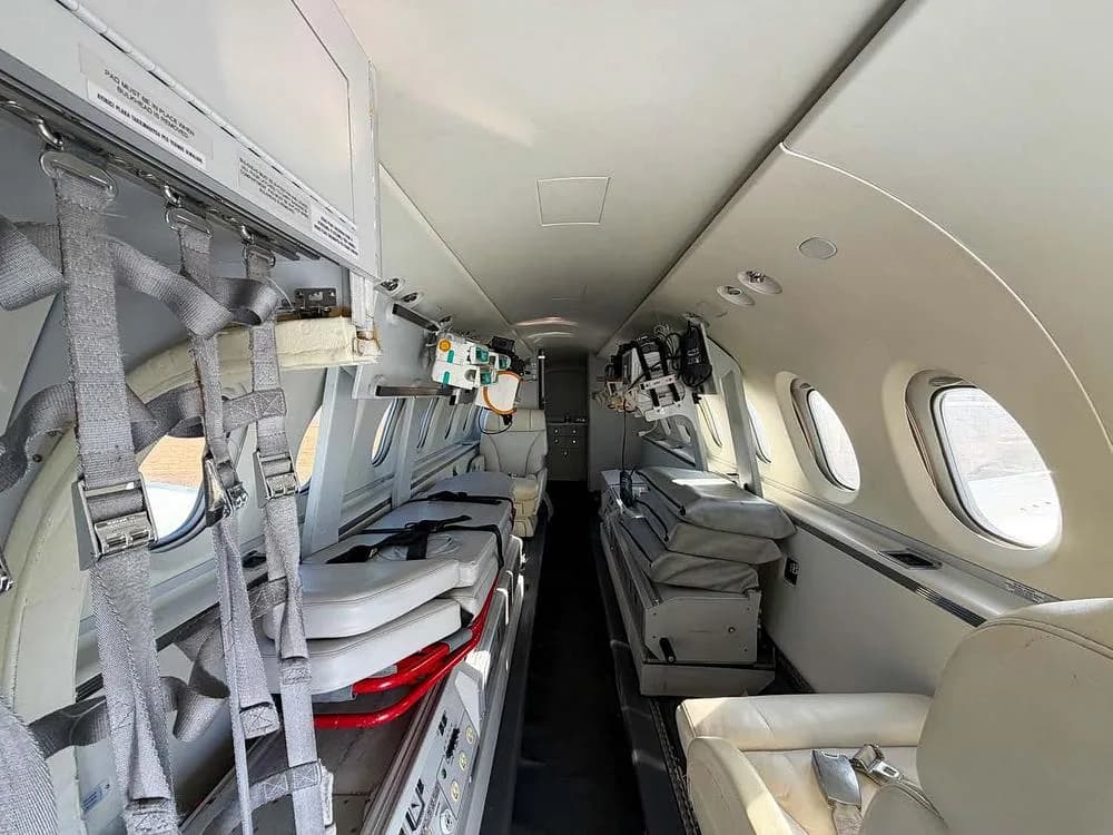 The interior of an aircraft cabin configured for air ambulance service, featuring stretchers and medical equipment.