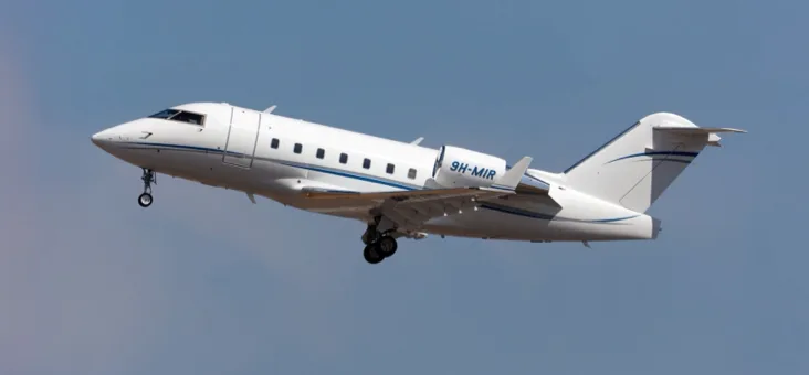 Challenger aircraft taking off with landing gear down.