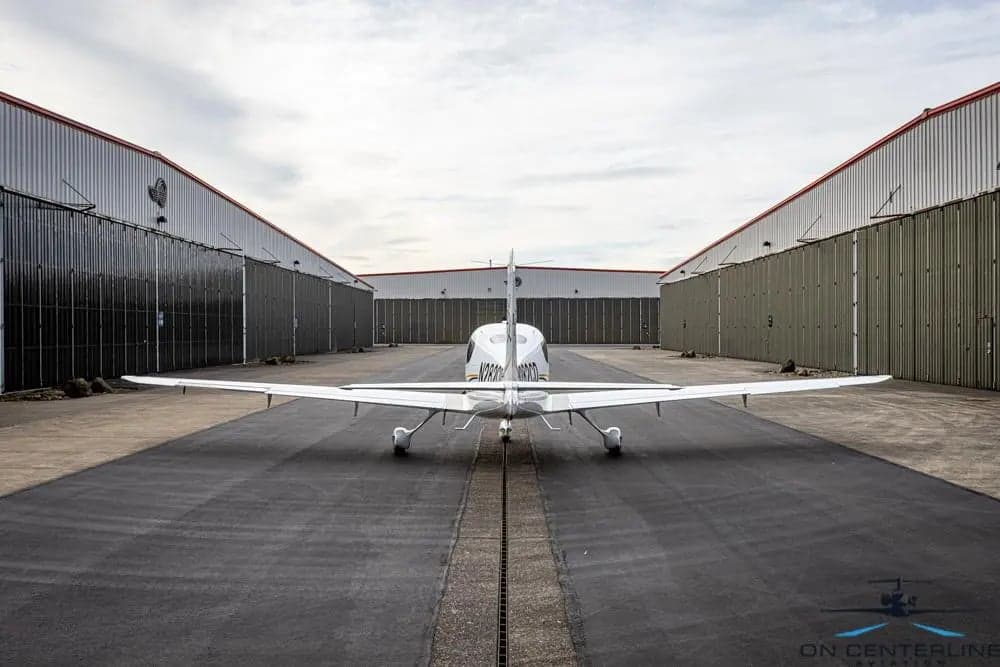Rear view of Cirrus SR22T aircraft N282CD parked on the tarmac.